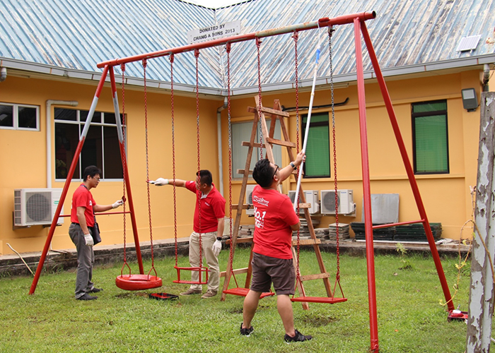 Hotlink team fixing playground swing